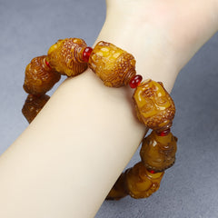 Amber Buddha Head Bracelet with Red Agate for Wealth, Protection, and Spiritual Balance