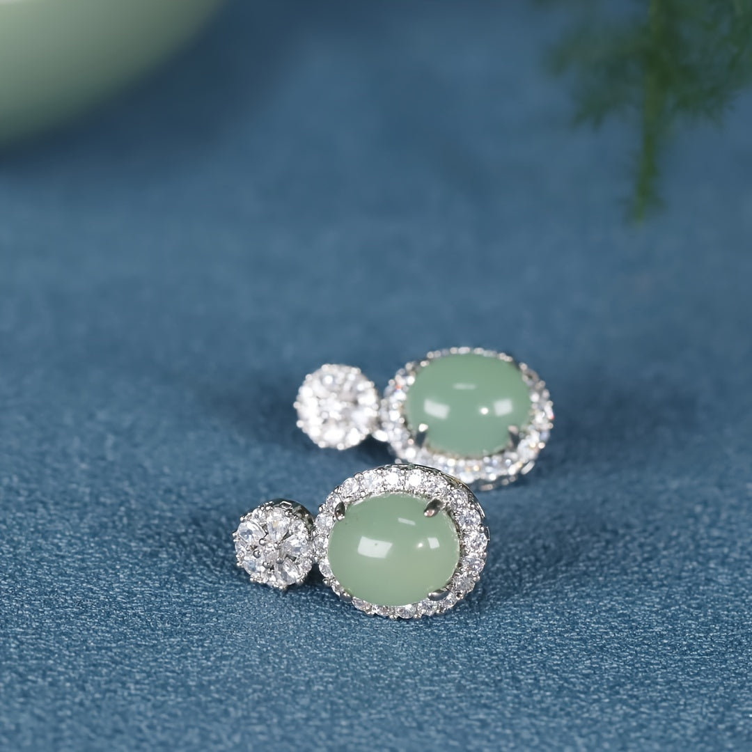 Earrings resting simply on a wooden surface, unadorned