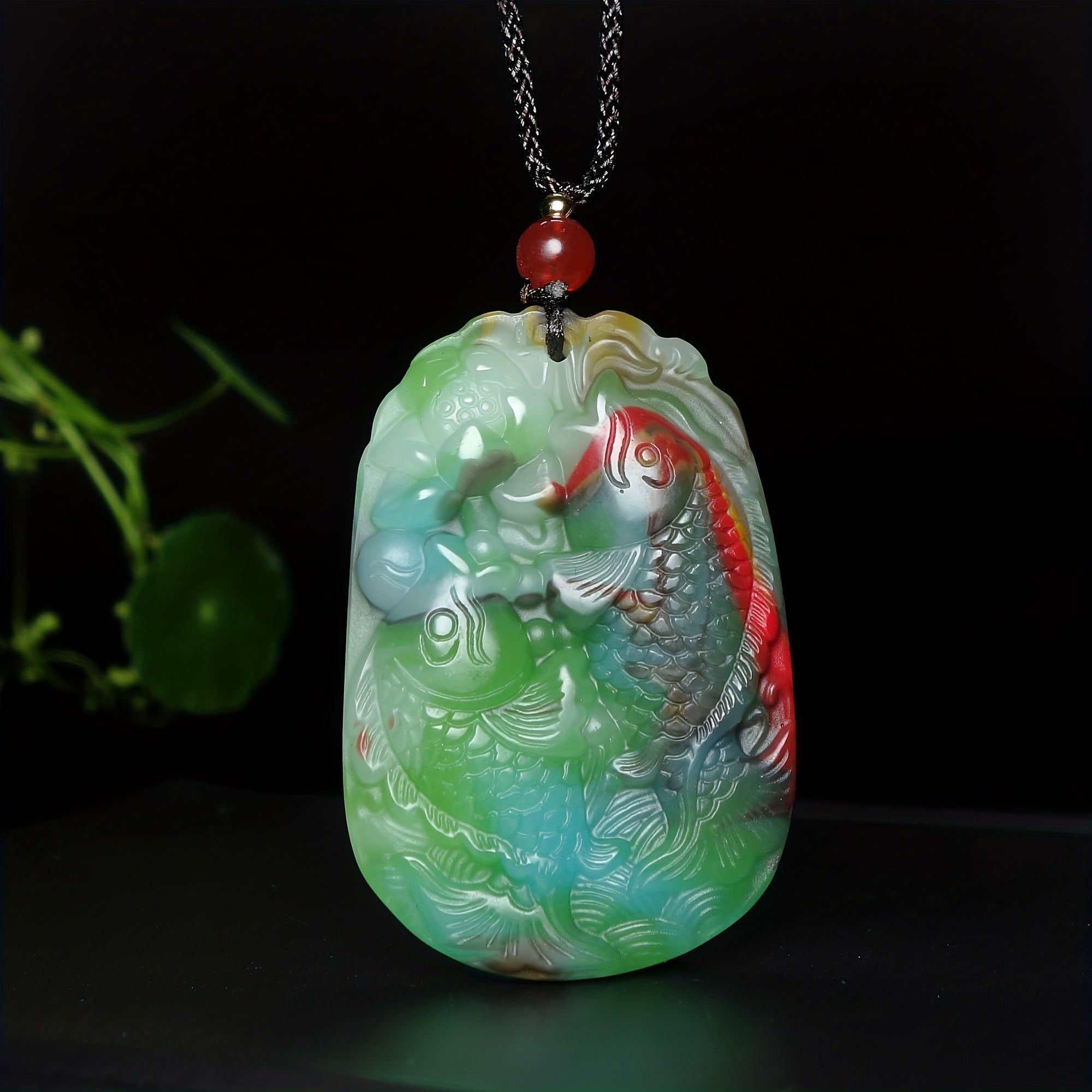 Lucky Fish pendant showing elegant stone carving and chain