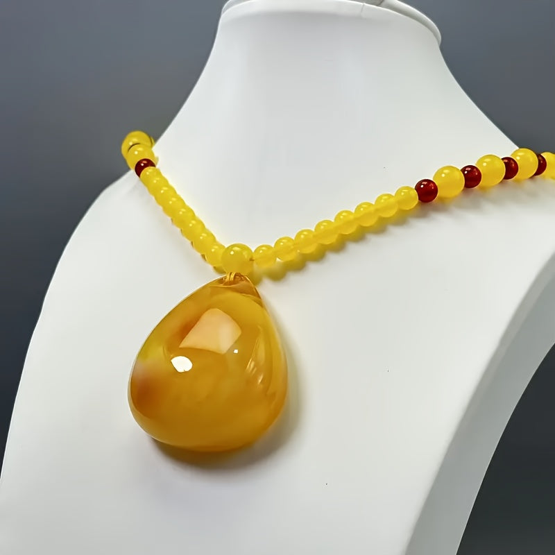 Amber pendant resting on natural surface