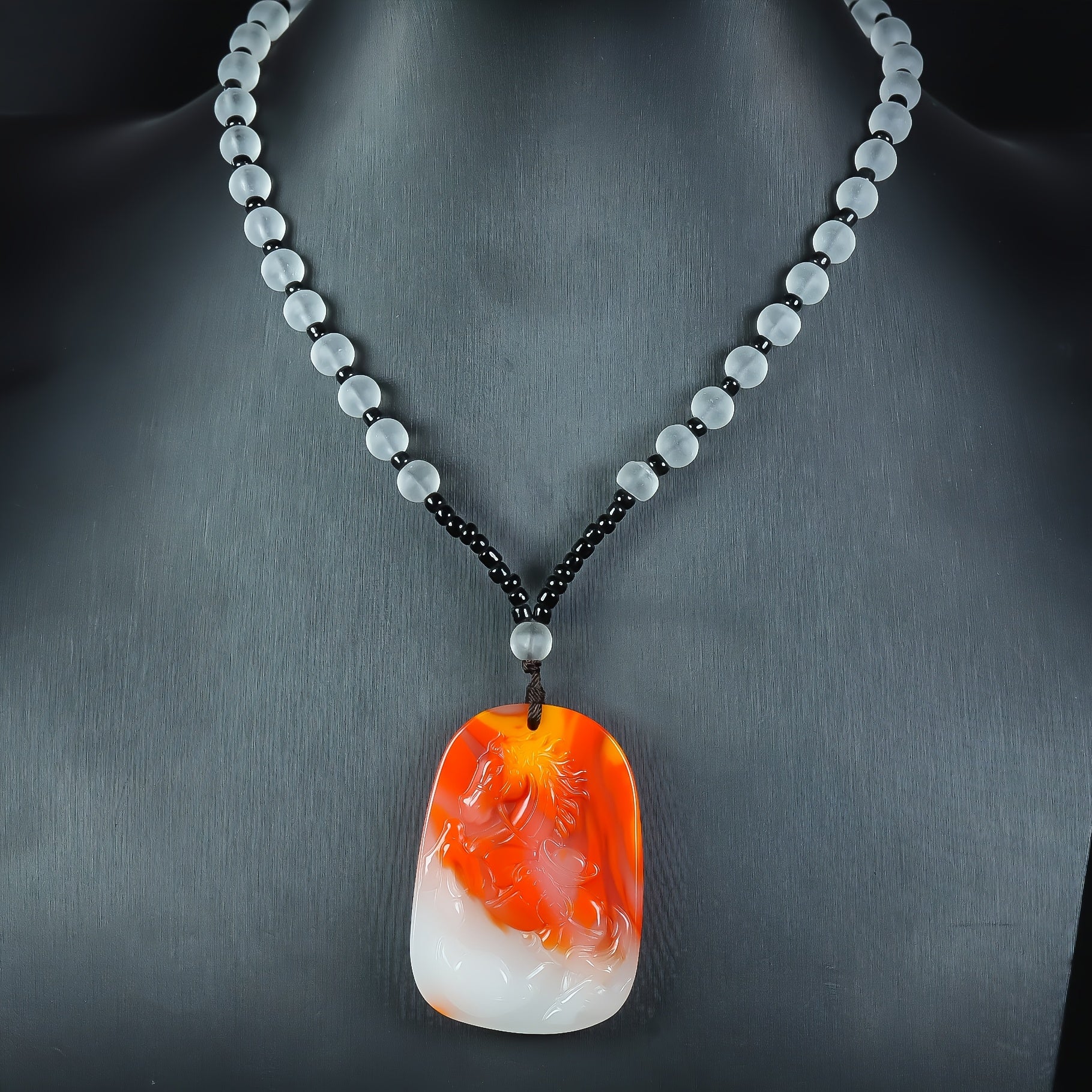 Close-up of the detailed carving on the horse pendant