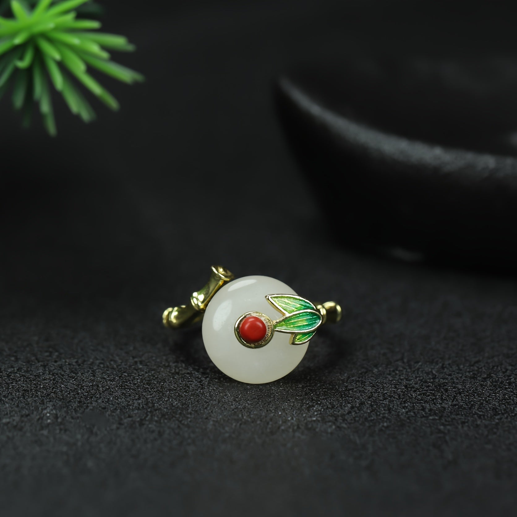 An elegant white jade ring with gold accents, symbolizing purity and prosperity.