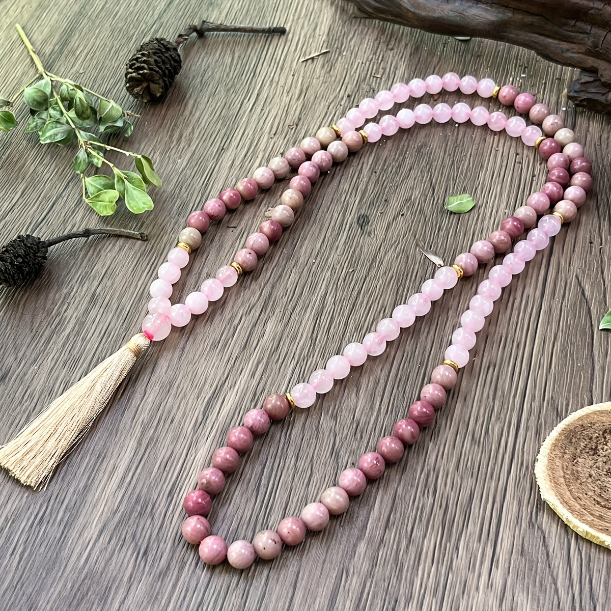 Rose Quartz and Rhodonite Mala Necklace laid in a circle