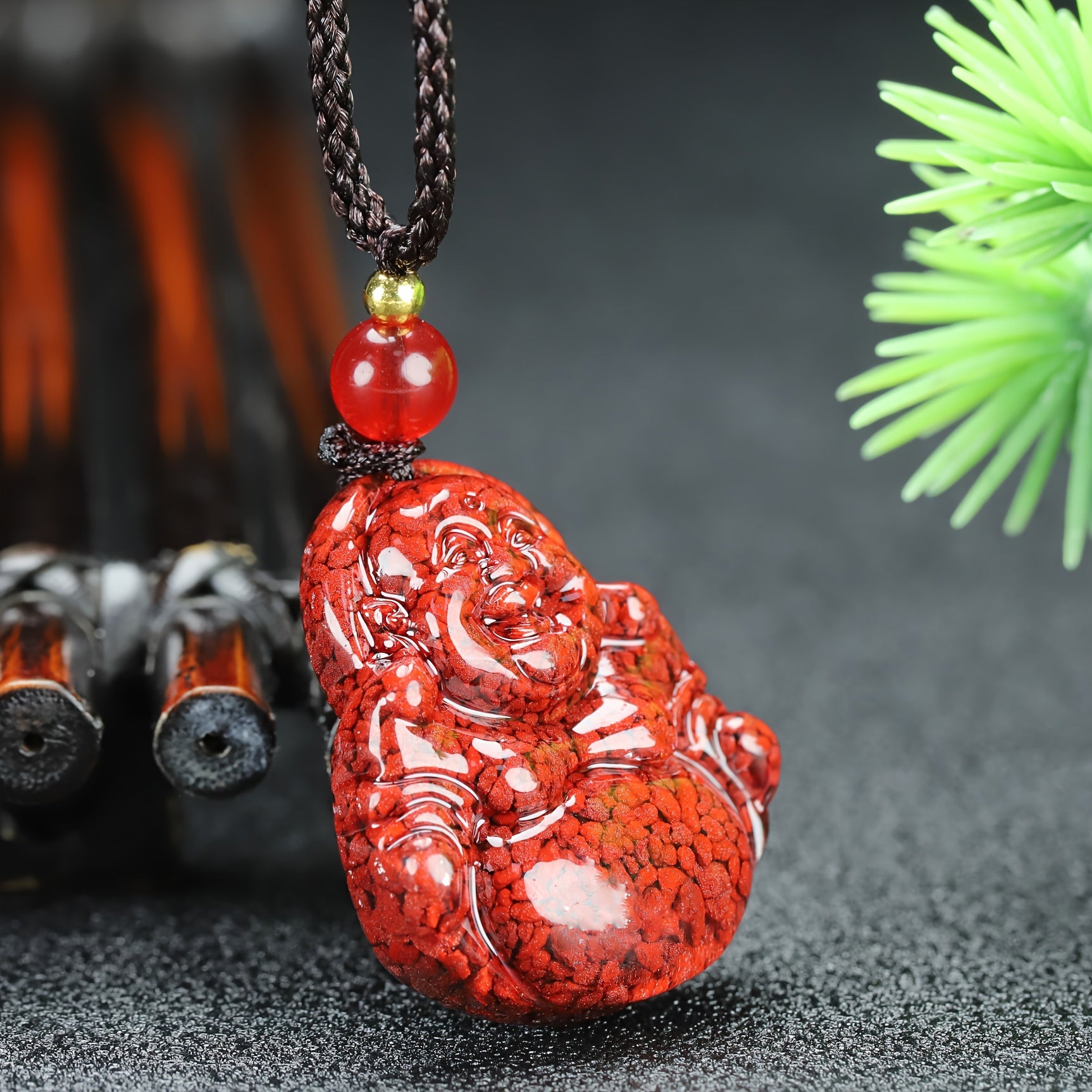 Hand carved cinnabar laughing character pendant detail