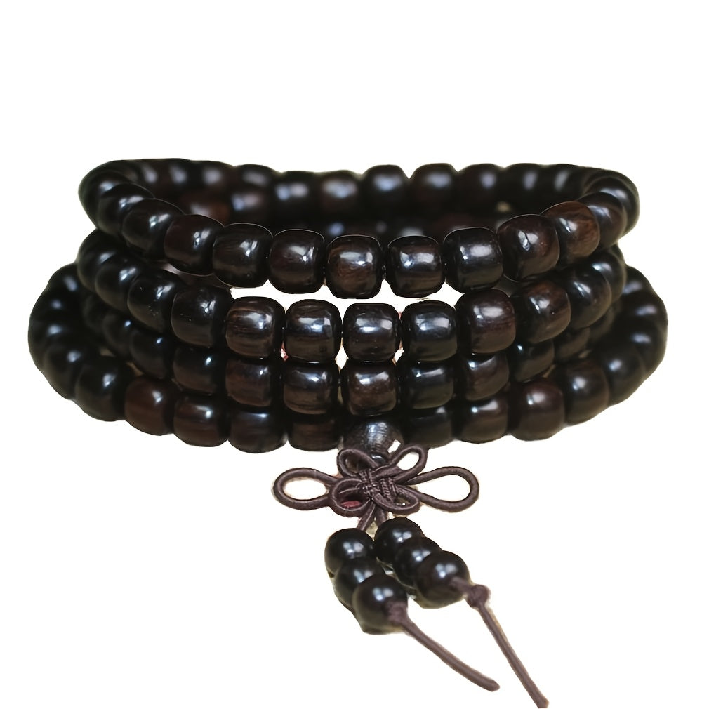 Close-up texture of black sandalwood beads showing grain