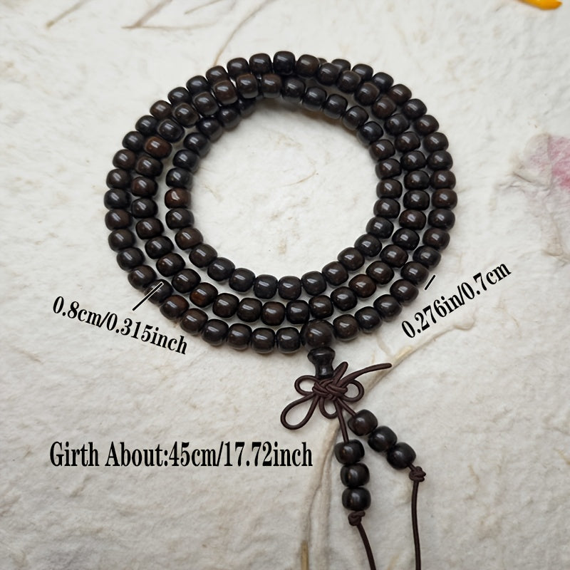 Black sandalwood mala wrapped loosely around a wrist