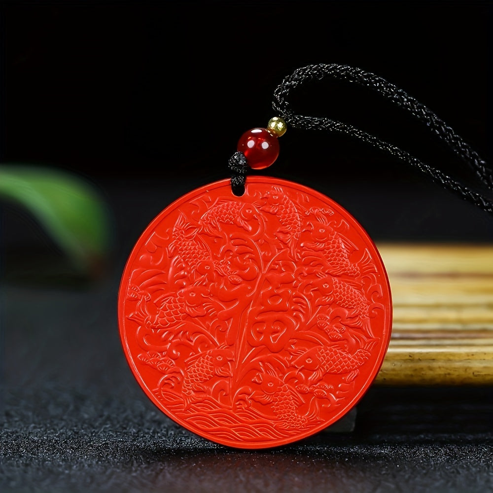A traditional cinnabar pendant carved with koi fish and the character for luck, showcasing the stone's rich color and intricate detail.